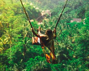 Woman on iconic Bali swing over jungle